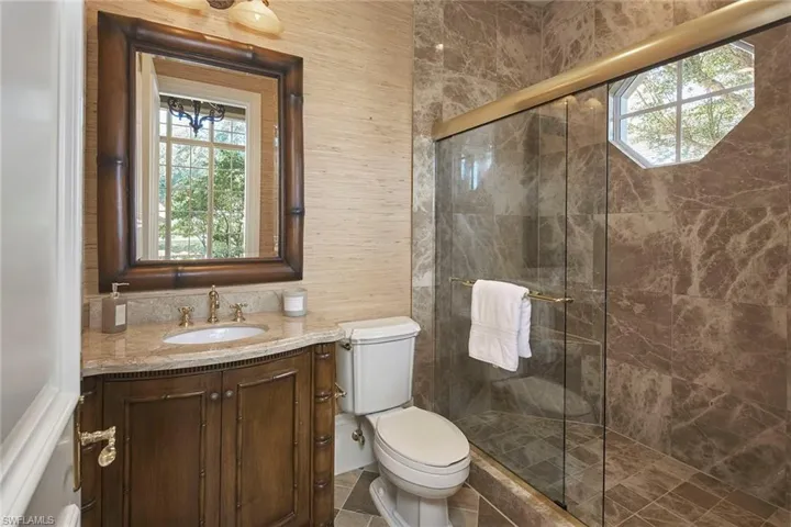 Full bath with a shower stall and vanity