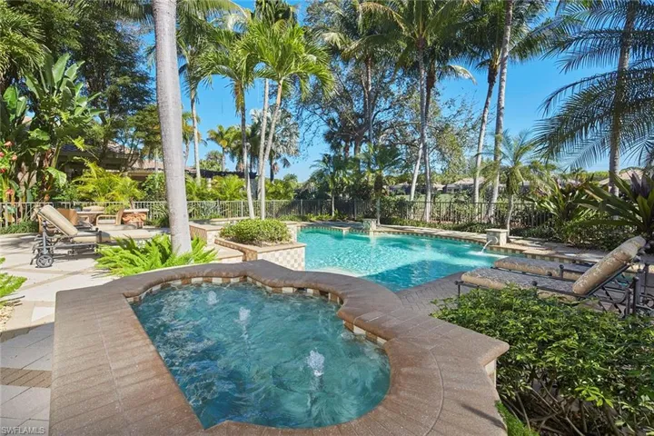 View of pool with a patio area, an in-ground hot tub, and a fenced backyard