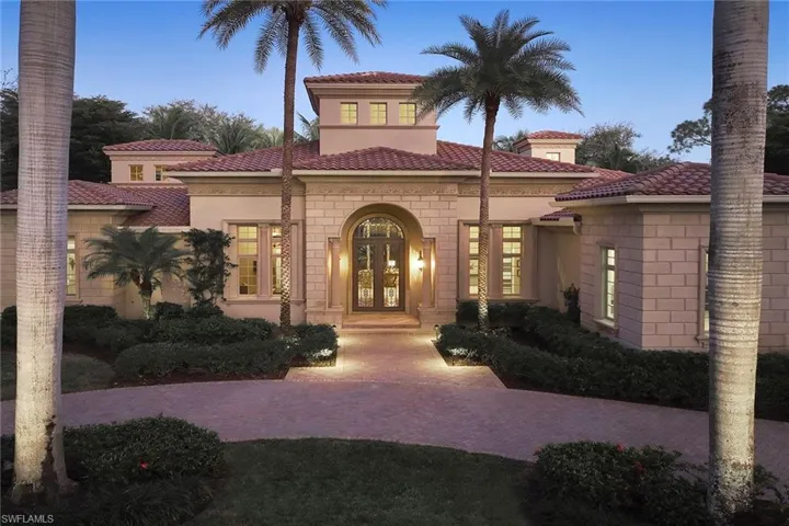 View of front of home with french doors, stucco siding, and a tiled roof