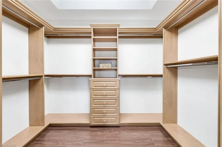 Spacious 10x10 closet with wood finish floors and lots of storage