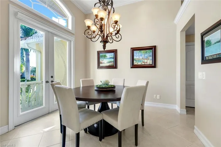 Dining room featuring ornamental molding, a chandelier, and healthy amount of natural light
