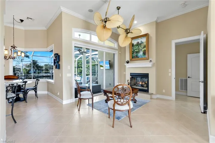 Dining room featuring ornamental molding, a chandelier, and healthy amount of natural light