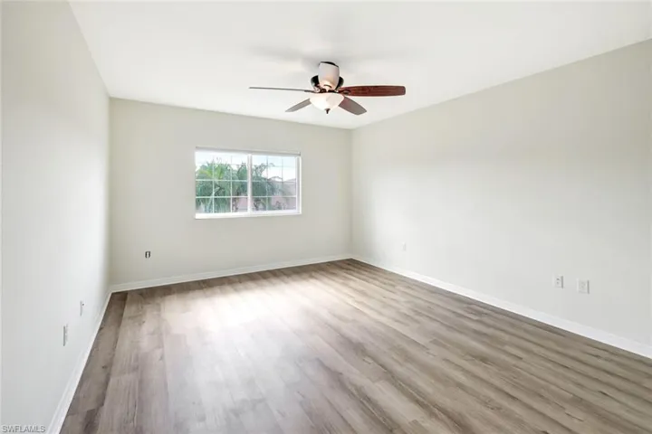 Spare room featuring ceiling fan and light hardwood / wood-style flooring
