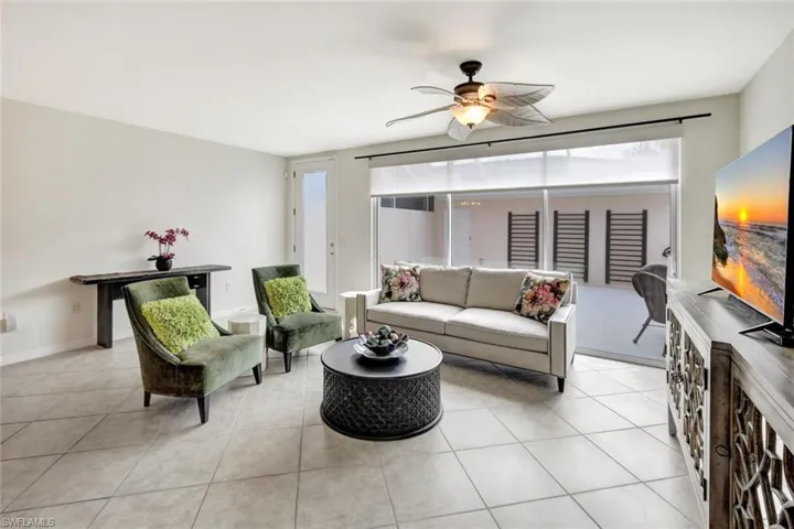 Tiled living room featuring ceiling fan