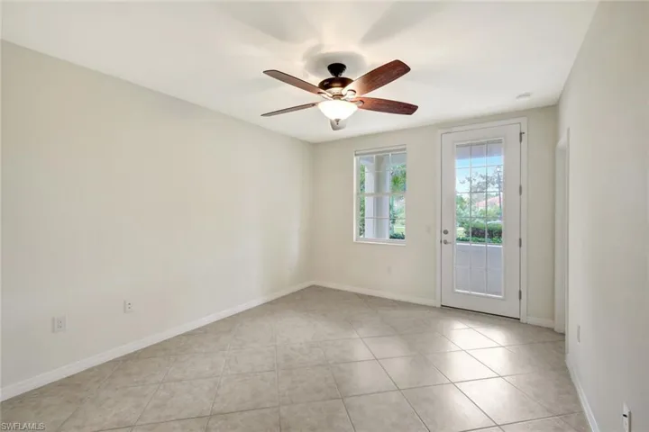 Unfurnished room with light tile patterned flooring and ceiling fan