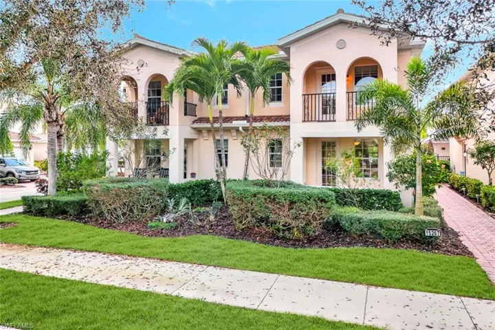 Mediterranean / spanish-style house featuring a front yard and a balcony