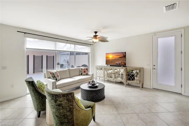 Tiled living room featuring ceiling fan