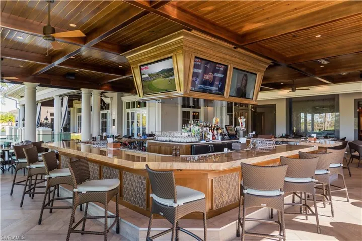 Club restaurant bar area featuring wood ceiling, coffered ceiling, recessed lighting, and a ceiling fan