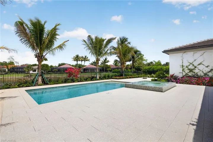 Tropical trees and plantings surround the outdoor living space