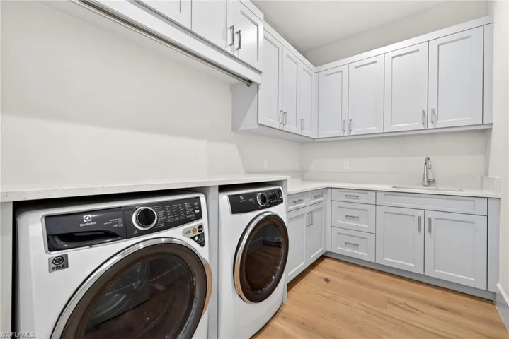 Large laundry room with lots of extra cabinets