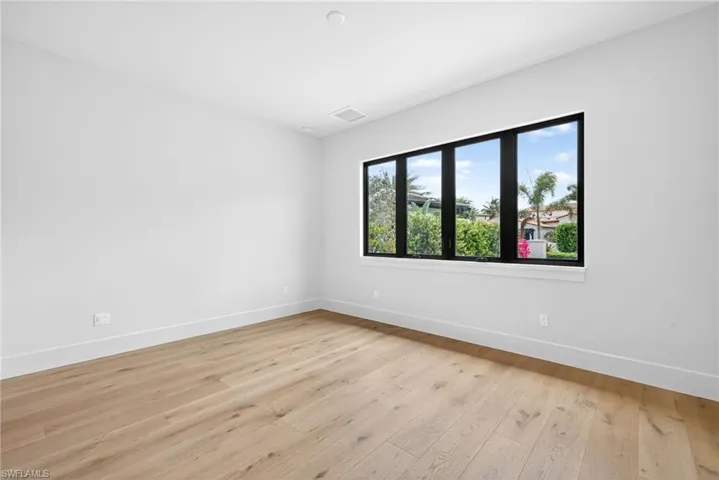 Bedroom 2 room featuring light wood floors and large window for lots of natural light