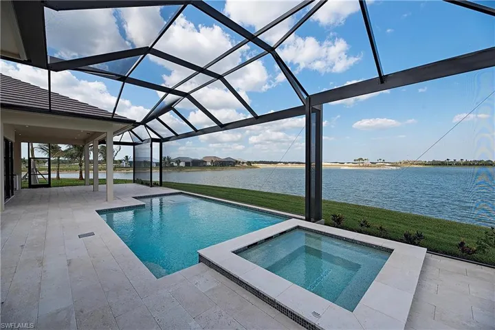Renderings/images are for illustration only, based on a prior model and may show upgrades. Pool with an inground hot tub, and screen enclosure.