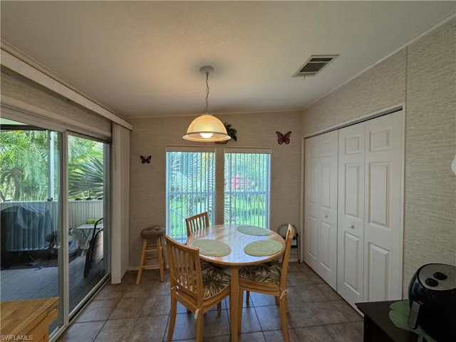 Dining area with visible vents and a textured ceiling