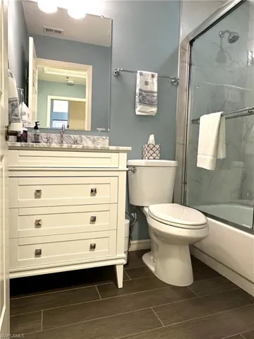 Updated bathroom with plank tile and enclosed tub