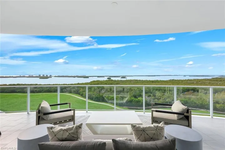 A spectacular vantage point from the lanai overlooking the lush golf course and tranquil bay below.