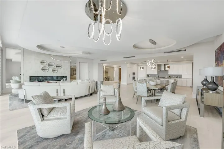 The dining, kitchen, and living areas transition fluidly, establishing a harmonious open layout.