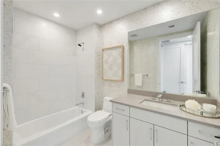 An ensuite guest bath with a classic shower-tub combination.