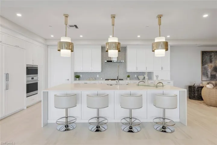 A striking kitchen featuring high-end appliances, a custom-designed backsplash, and abundant counter space for seamless functionality.