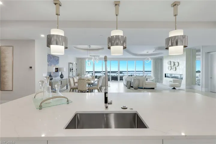 Framed by panoramic Gulf views, the kitchen offers a stunning backdrop for even the simplest tasks.