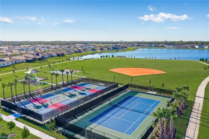 Community amenities featuring multiple tennis courts, pickleball courts, a baseball field, and a playground