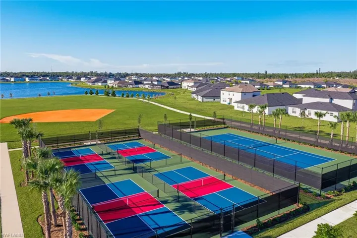 Hardscaped pickleball and tennis courts featuring black fencing