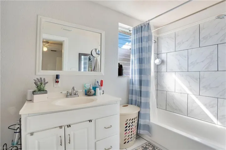 Bathroom with vanity and shower / bath combo