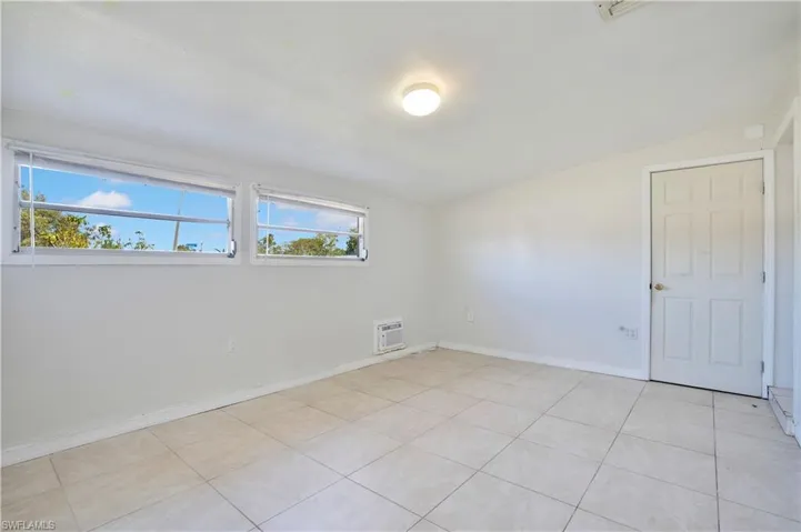 Unfurnished room with baseboards and light tile patterned floors