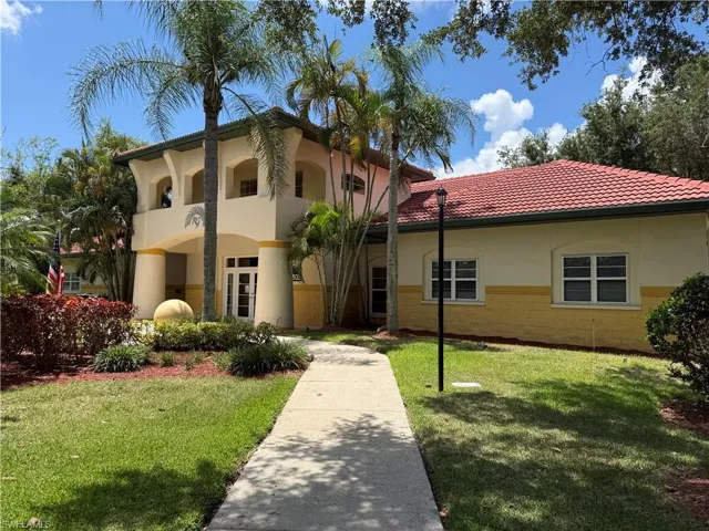 Architectural facade featuring a red tile roof and arched entryways