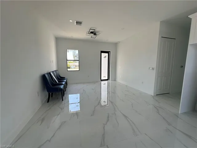 Entrance foyer with recessed lighting, marble finish floor, visible vents, and baseboards