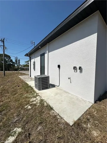 View of property exterior featuring cooling unit and stucco siding