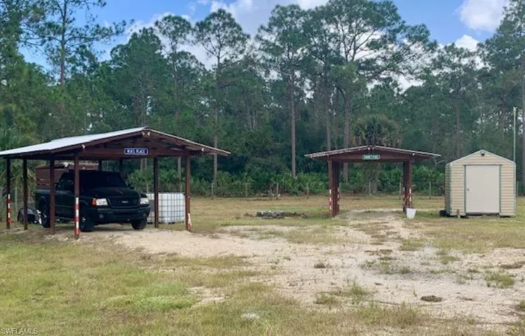View of yard featuring a shed and a carport