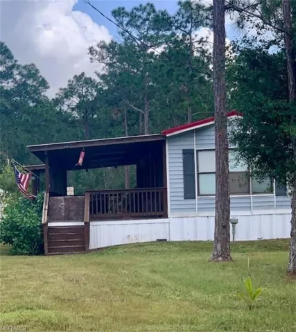 View of side of home with a lawn