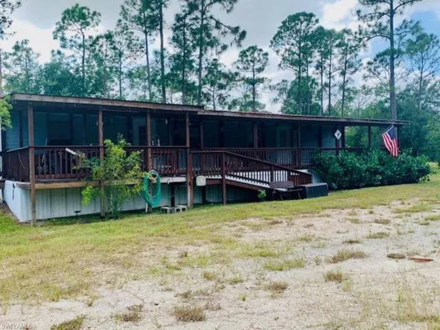 Rear view of house featuring a wooden deck