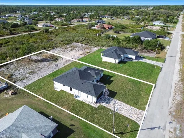 Aerial view of residential area featuring property boundaries highlighted