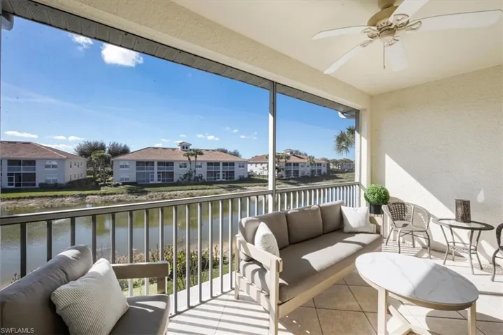 Sunroom / solarium featuring a water view, ceiling fan, an outdoor hangout area, a textured wall, and a balcony