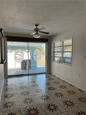 Spare room featuring a wealth of natural light and baseboards