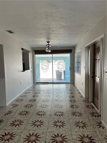 Unfurnished room with baseboards and visible vents