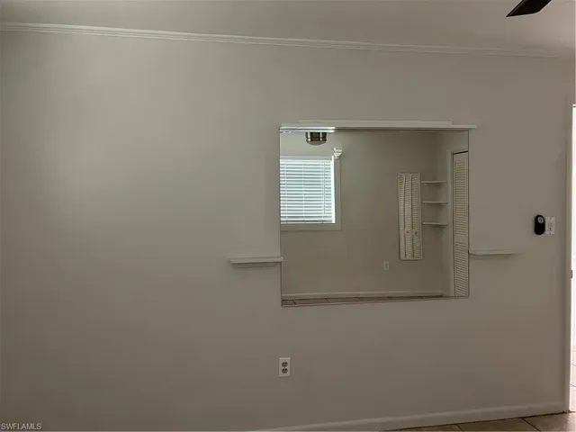 Interior details featuring ceiling fan, crown molding, and baseboards