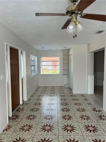 Empty room with visible vents and a textured ceiling