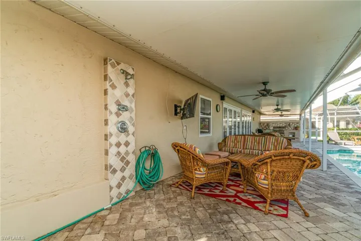 View of patio with an outdoor hangout area, a sunroom, a ceiling fan, an outdoor pool, and a lanai