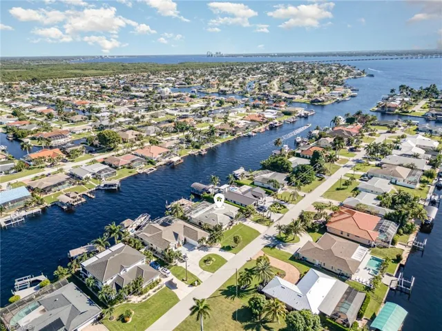 View of property location with a large body of water and nearby suburban area
