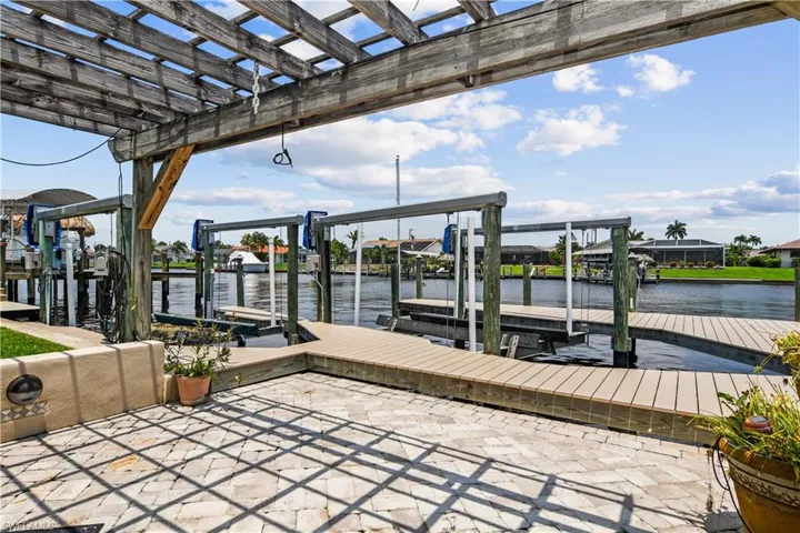 Dock with boat lift and a water view