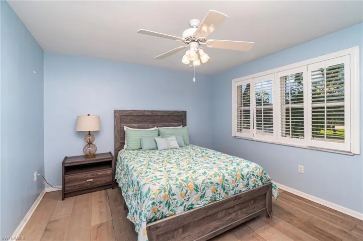 Bedroom with wood-type flooring and a ceiling fan