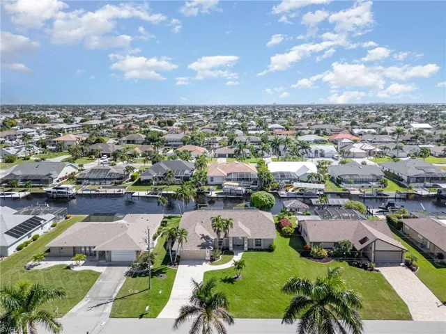 Aerial perspective of suburban area featuring a nearby body of water