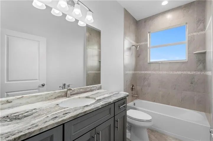 Full bathroom with shower / washtub combination, vanity, and toilet