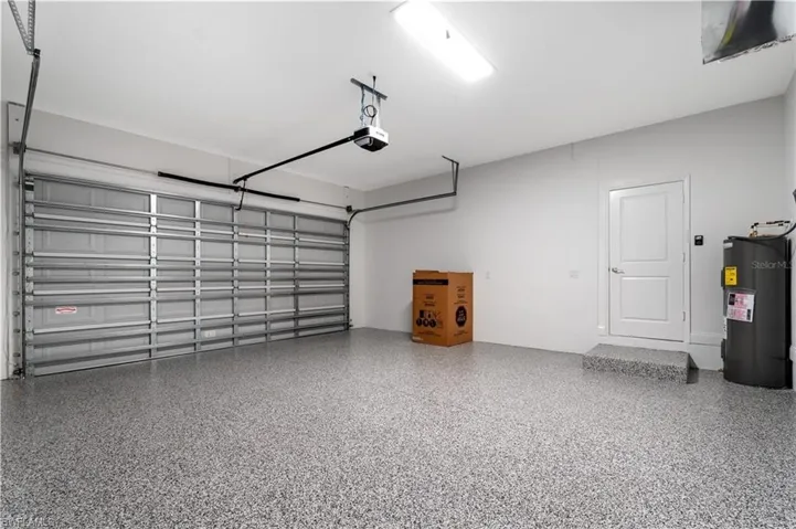 Garage with water heater and a garage door opener