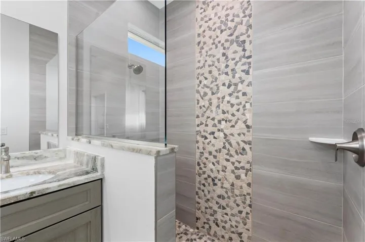 Full bath with a walk in shower and vanity