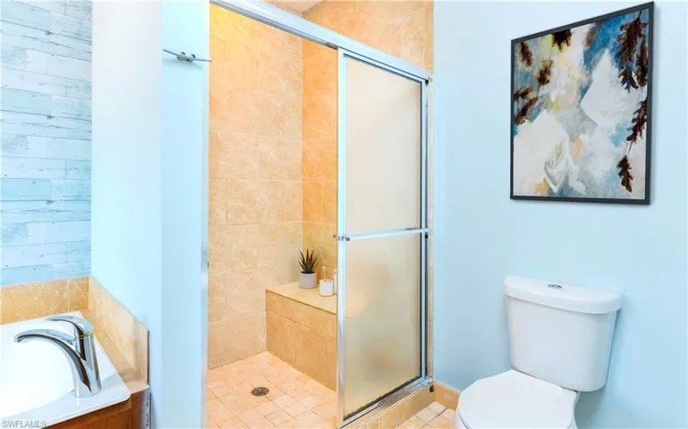 Bathroom with a shower stall and a garden tub