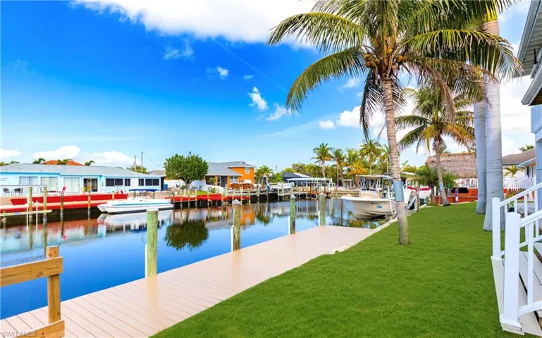 Dock featuring a yard, a water view, and a residential view