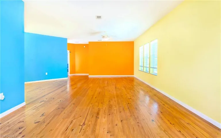 Unfurnished room featuring light wood-style floors and ceiling fan